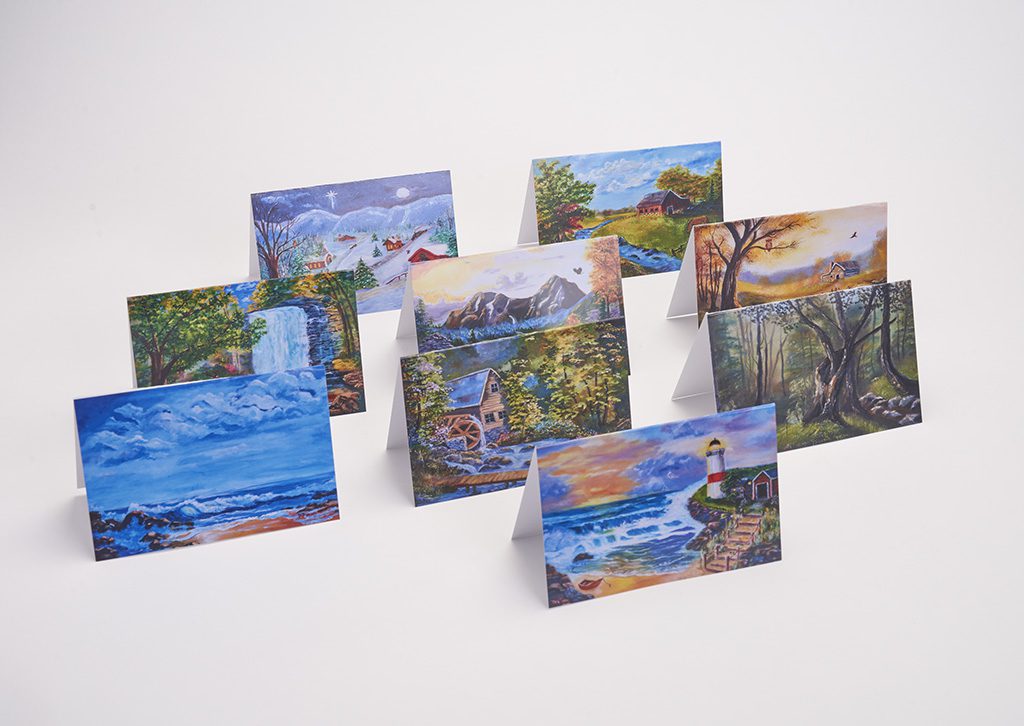 A set of eight cards with paintings on them.